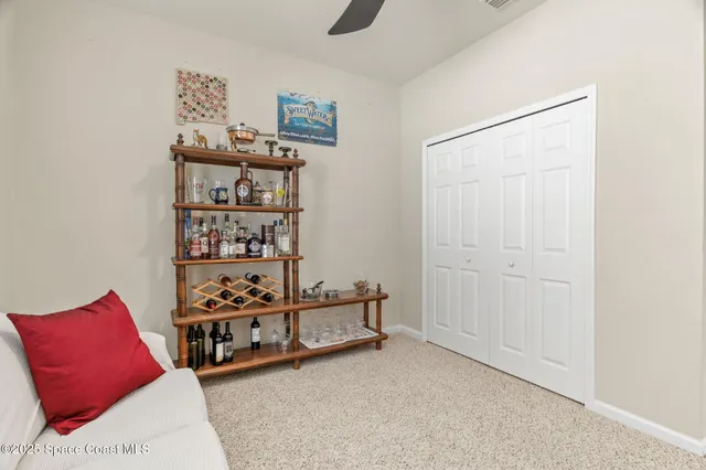 a kitchen with granite countertop a refrigerator sink and white cabinets