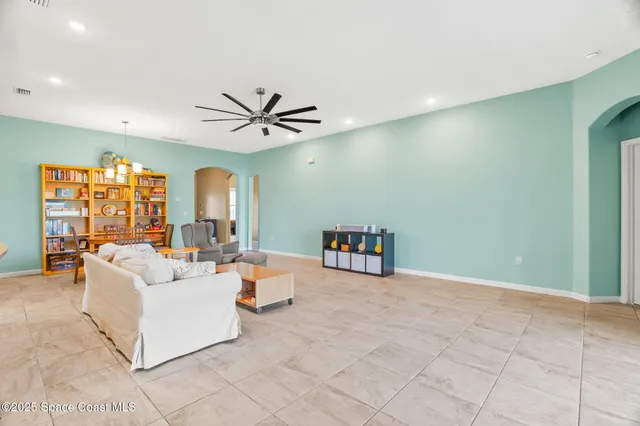 a living room with furniture and view of kitchen