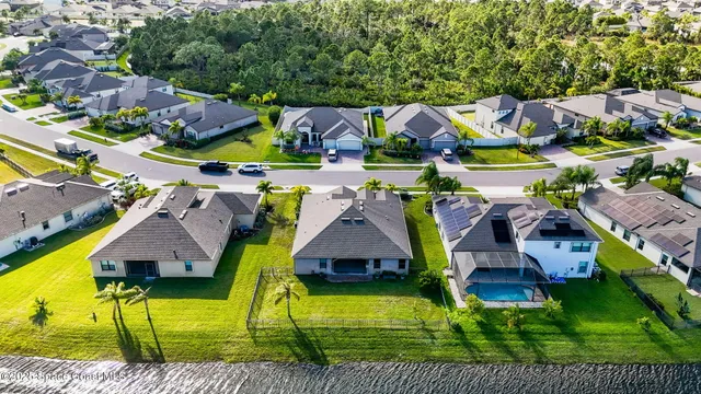 an aerial view of a house with outdoor space and lake view