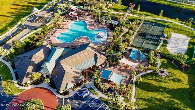 a living room with couches a table and chairs with potted plants