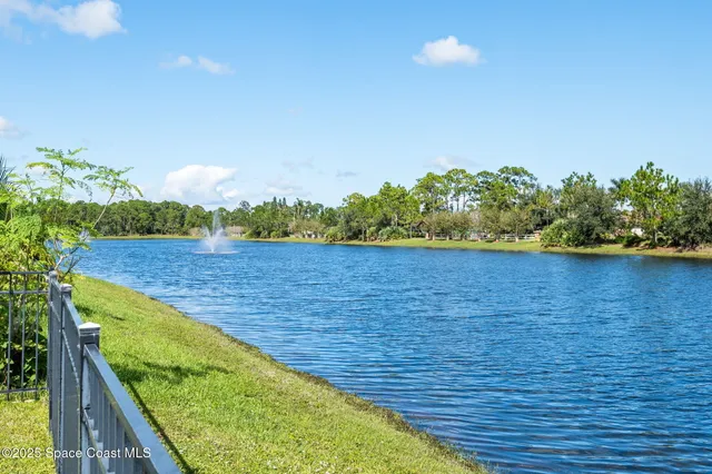 a view of a hallway with windows and entryway