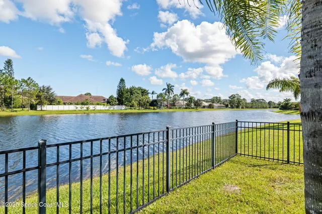 a kitchen with a refrigerator a stove and a dining table with wooden floor