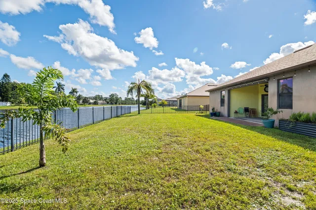 a kitchen with a sink a counter space appliances and cabinets