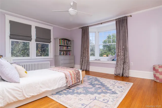 a bedroom with furniture and a window