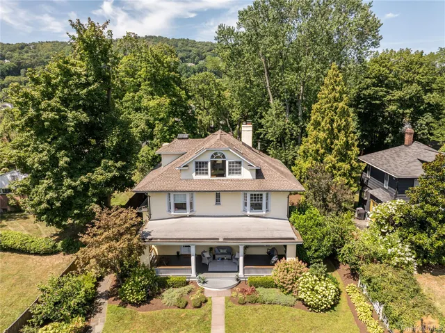an aerial view of a house with a yard