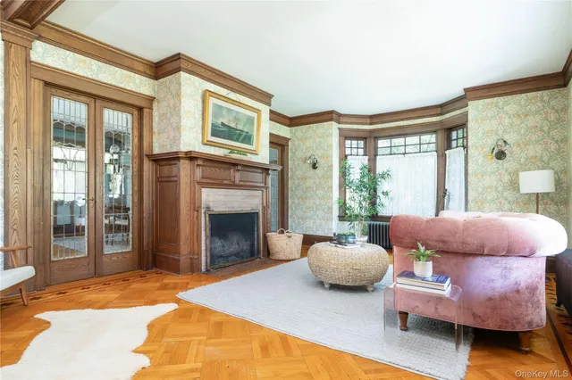 a dining room with wooden floor a chandelier a wooden table and chairs