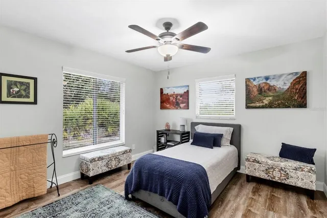 a bedroom with a bed and wooden floor