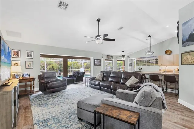 a living room with furniture ceiling fan and a window