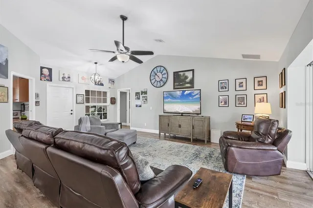 a living room with furniture a rug and white walls