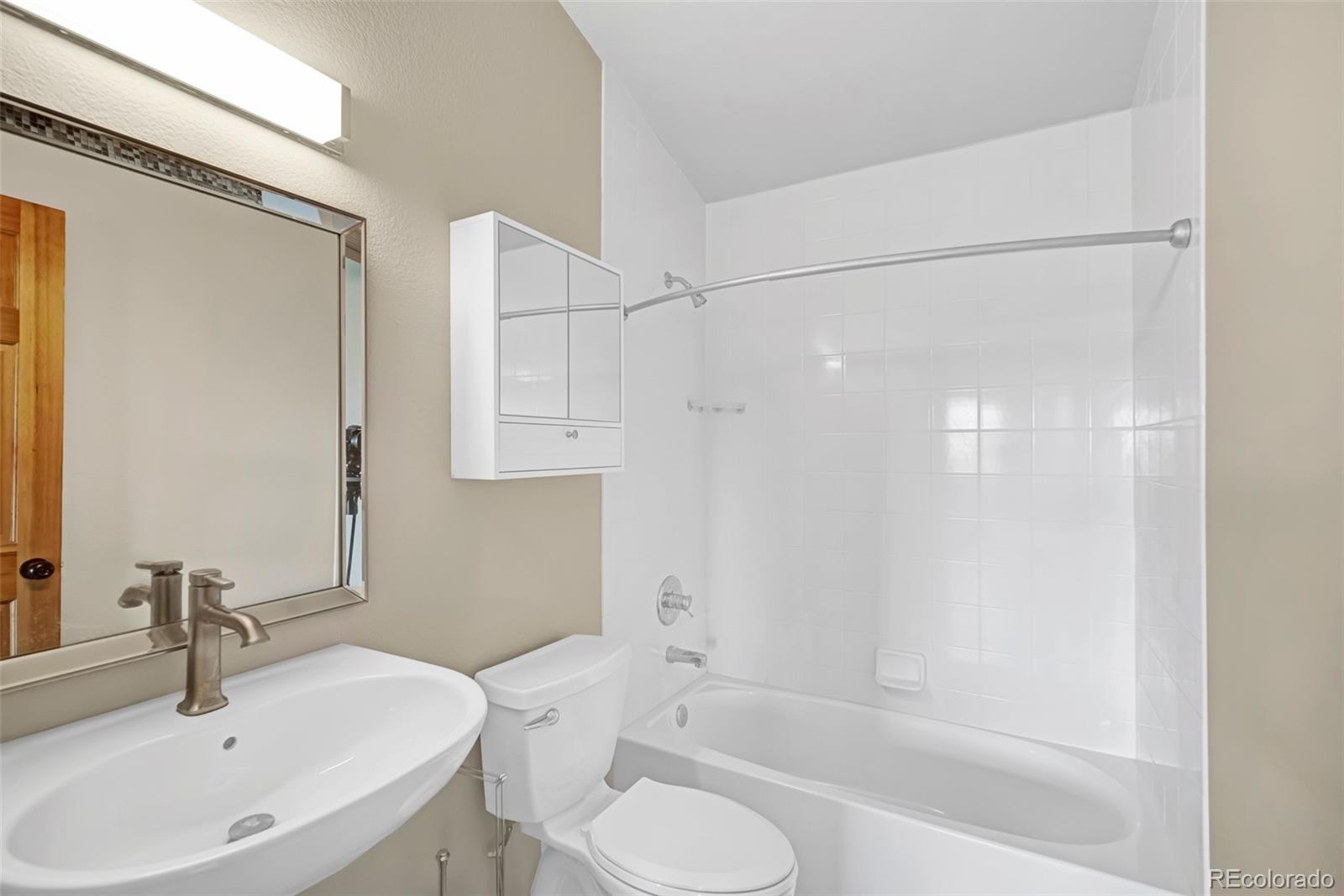 2491 Stagestop Road Jefferson, CO 80456 - Photo 15 of 46 a bathroom with a sink toilet and shower