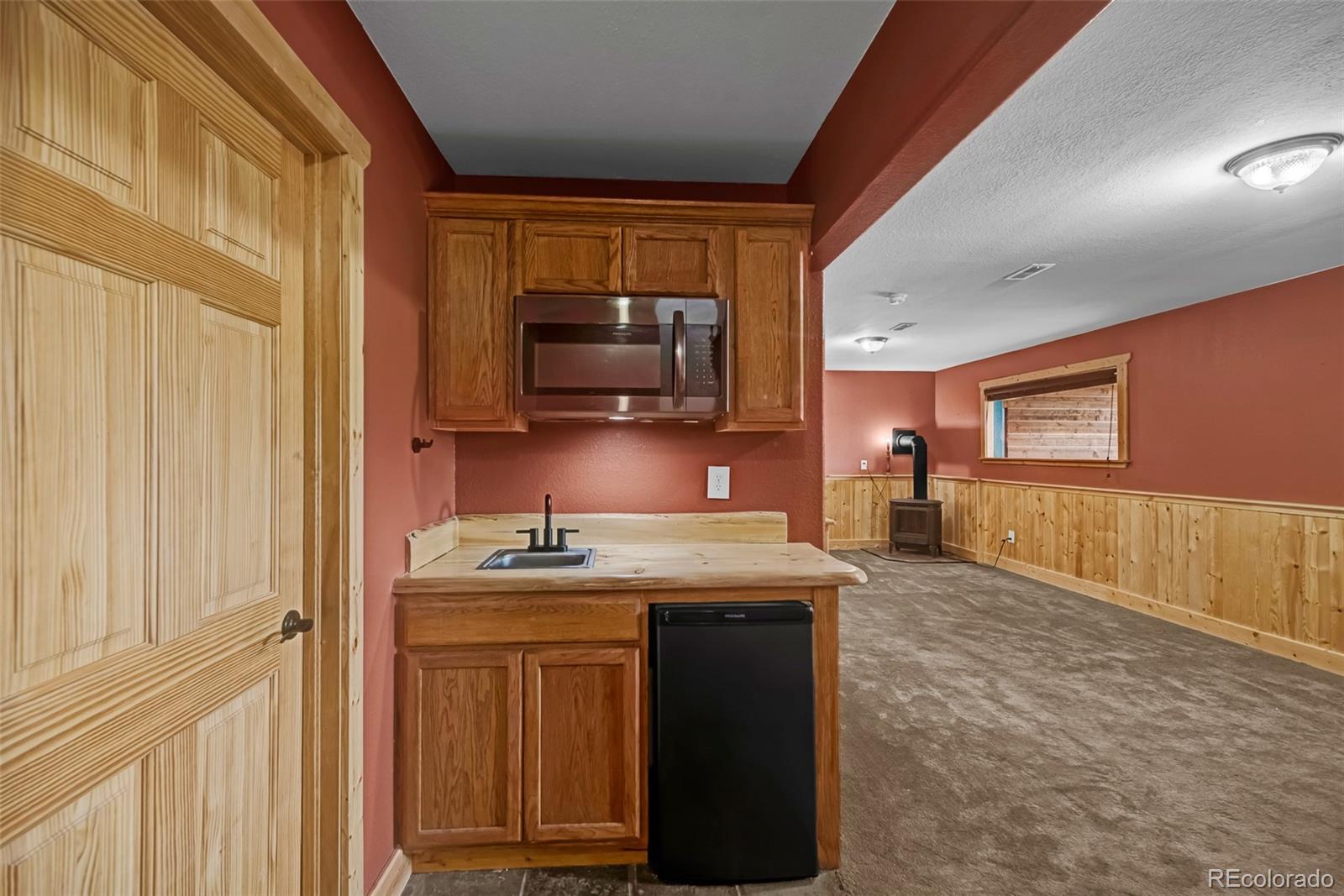 2491 Stagestop Road Jefferson, CO 80456 - Photo 19 of 46 a kitchen with stainless steel appliances granite countertop a stove a sink and a microwave