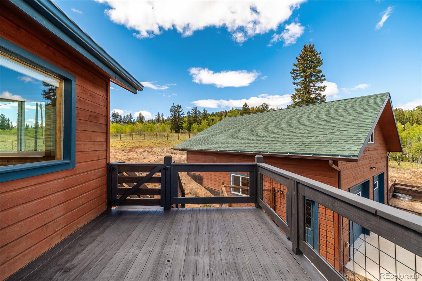 2491 Stagestop Road Jefferson, CO 80456 - Photo 26 of 46 a view of a balcony with chair and wooden floor
