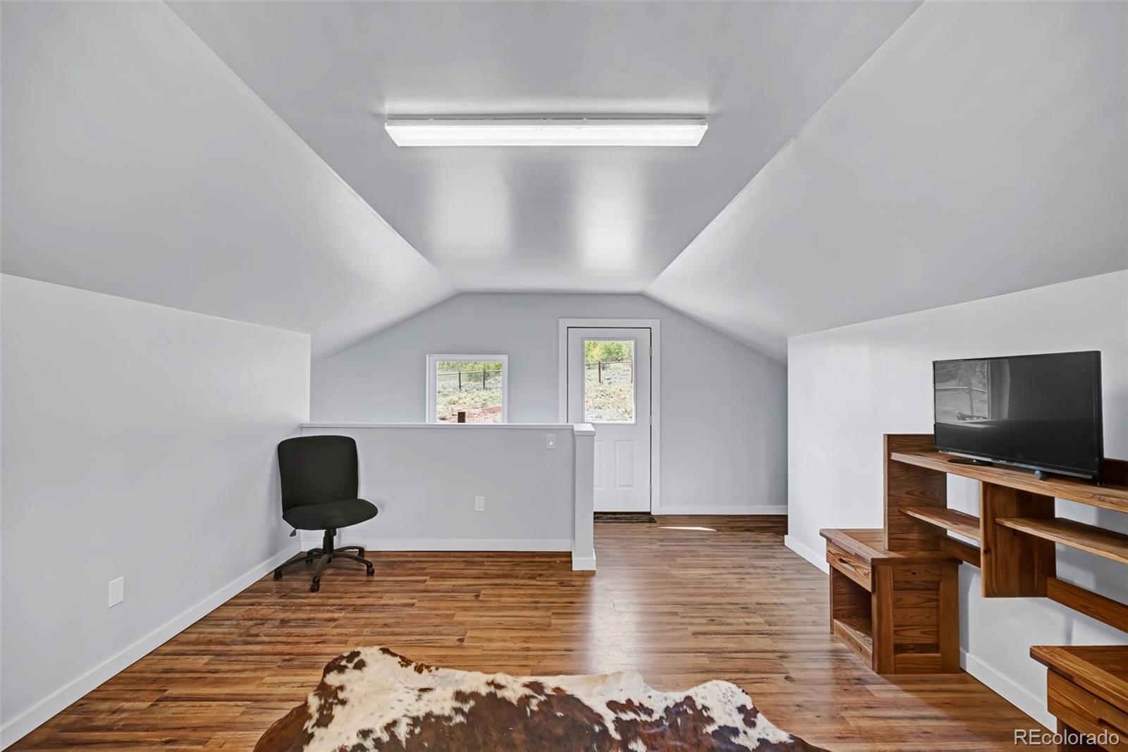 2491 Stagestop Road Jefferson, CO 80456 - Photo 29 of 46 a living room with furniture and a flat screen tv