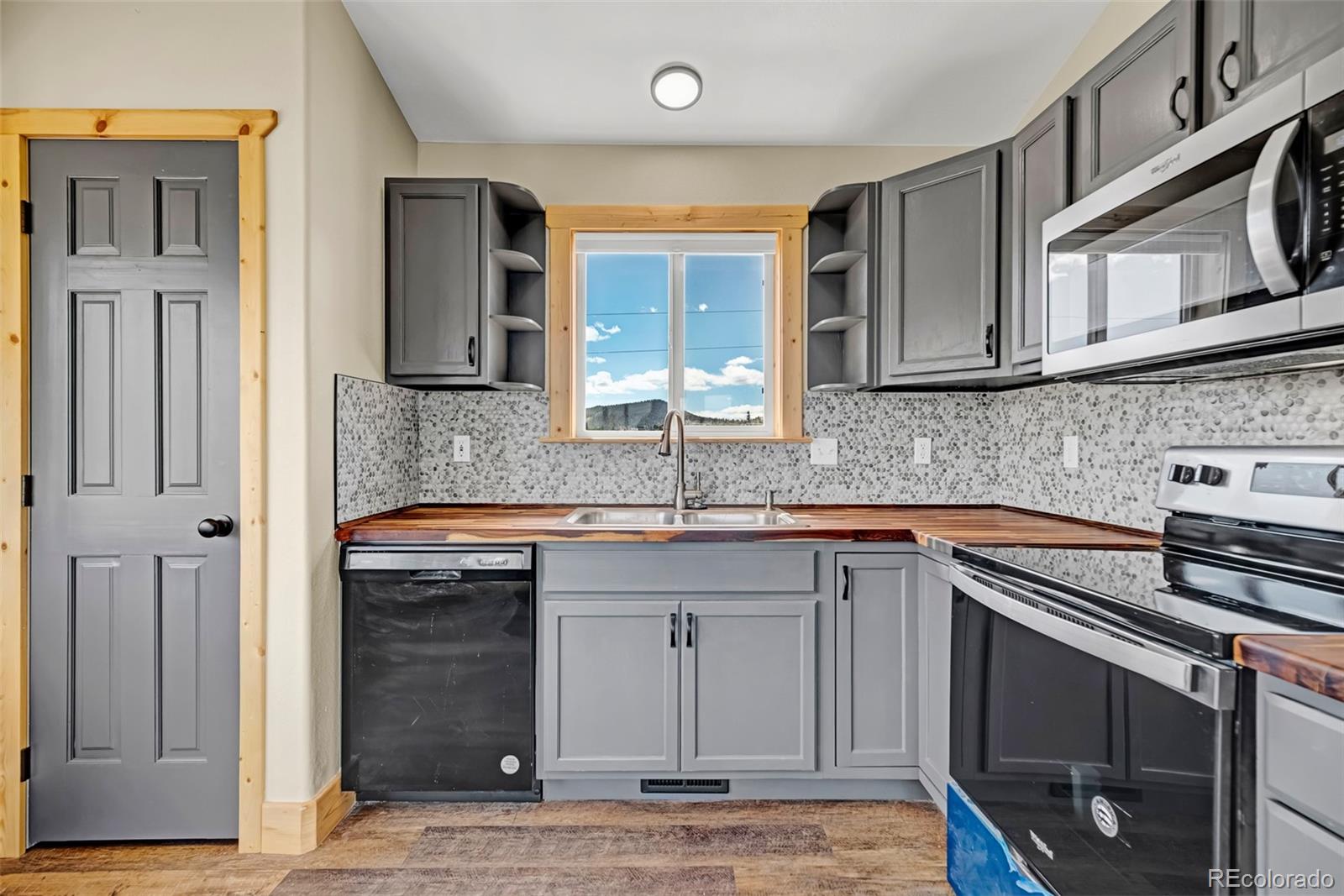 2491 Stagestop Road Jefferson, CO 80456 - Photo 3 of 46 a kitchen with stainless steel appliances granite countertop a sink stove and cabinets