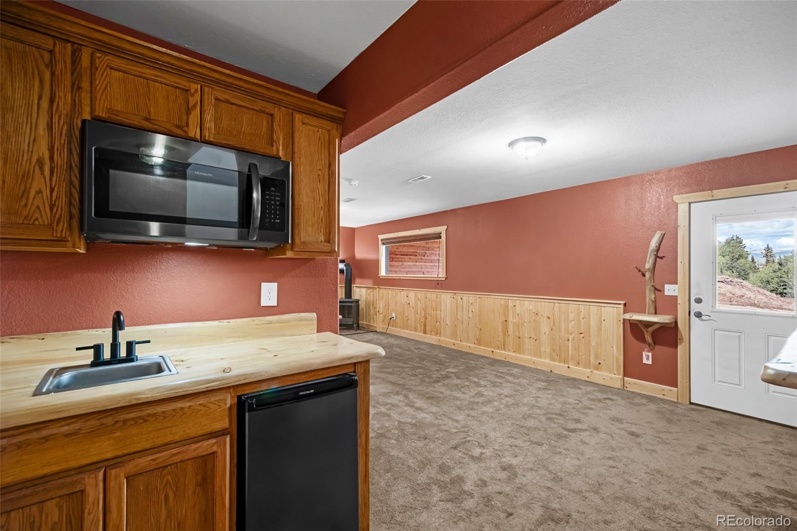 2491 Stagestop Road Jefferson, CO 80456 - Photo 4 of 46 a kitchen with a sink a stove and microwave
