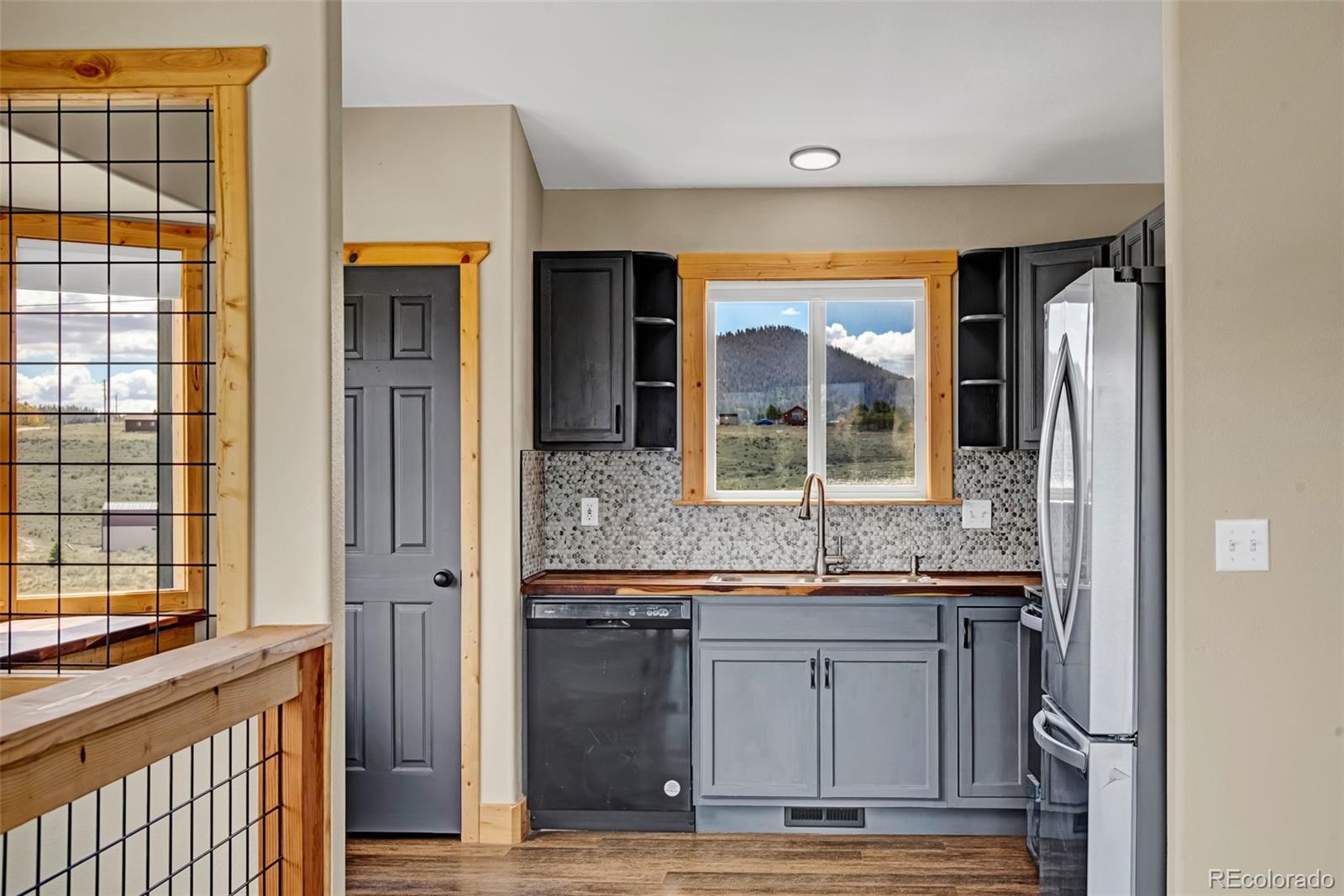 2491 Stagestop Road Jefferson, CO 80456 - Photo 10 of 46 a view of kitchen with granite countertop cabinets and window