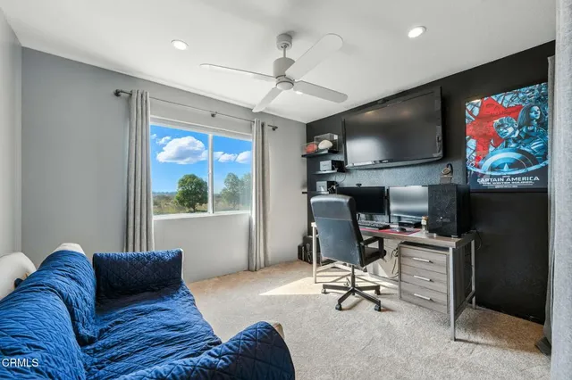 a bedroom with furniture and a flat screen tv