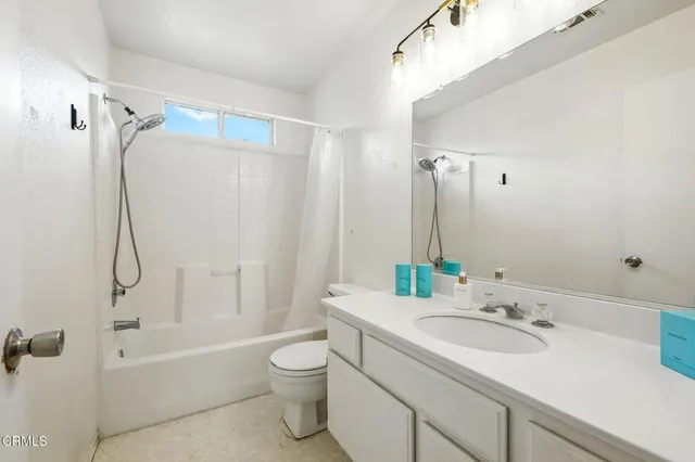 a bathroom with a sink toilet tub and shower