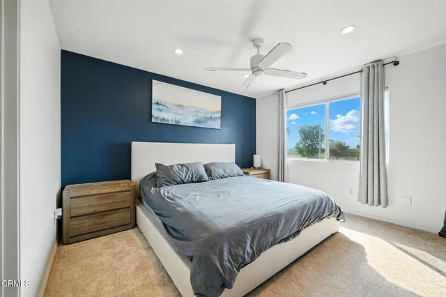 a bedroom with a large bed and a window