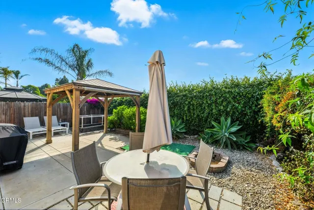 a view of a patio with table and chairs potted plants with wooden floor