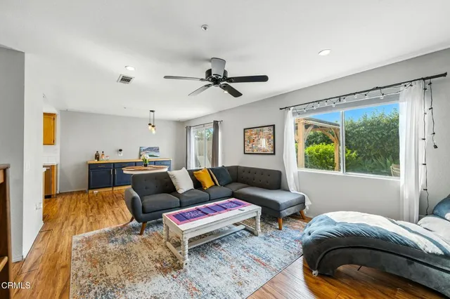 a living room with furniture and a large window