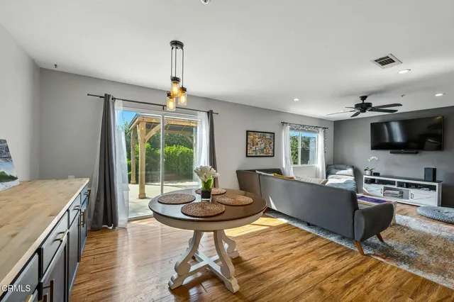 a living room with furniture a window and a flat screen tv