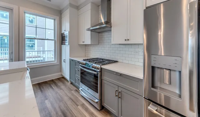 a kitchen with stainless steel appliances a stove and a refrigerator