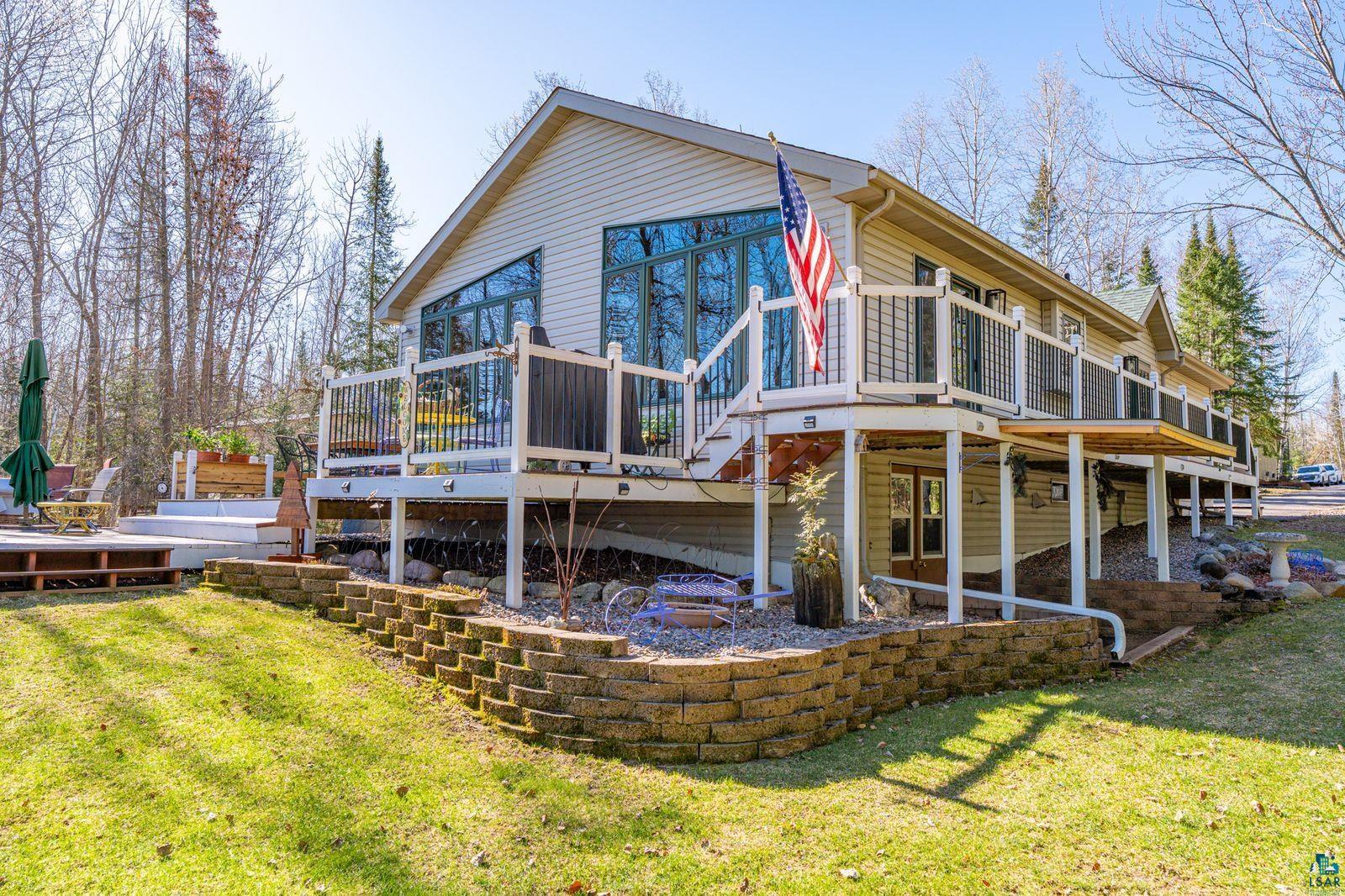 4452 Moccasin Point Road Tower, MN 55790 - Photo 29 of 44 Exterior siding with a multi-level deck featuring white railings and dark balusters