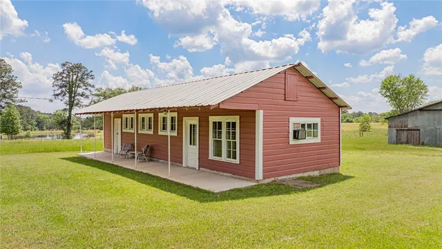 a view of a house with a yard patio and fire pit