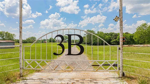 a view of a tennis ground with a big yard