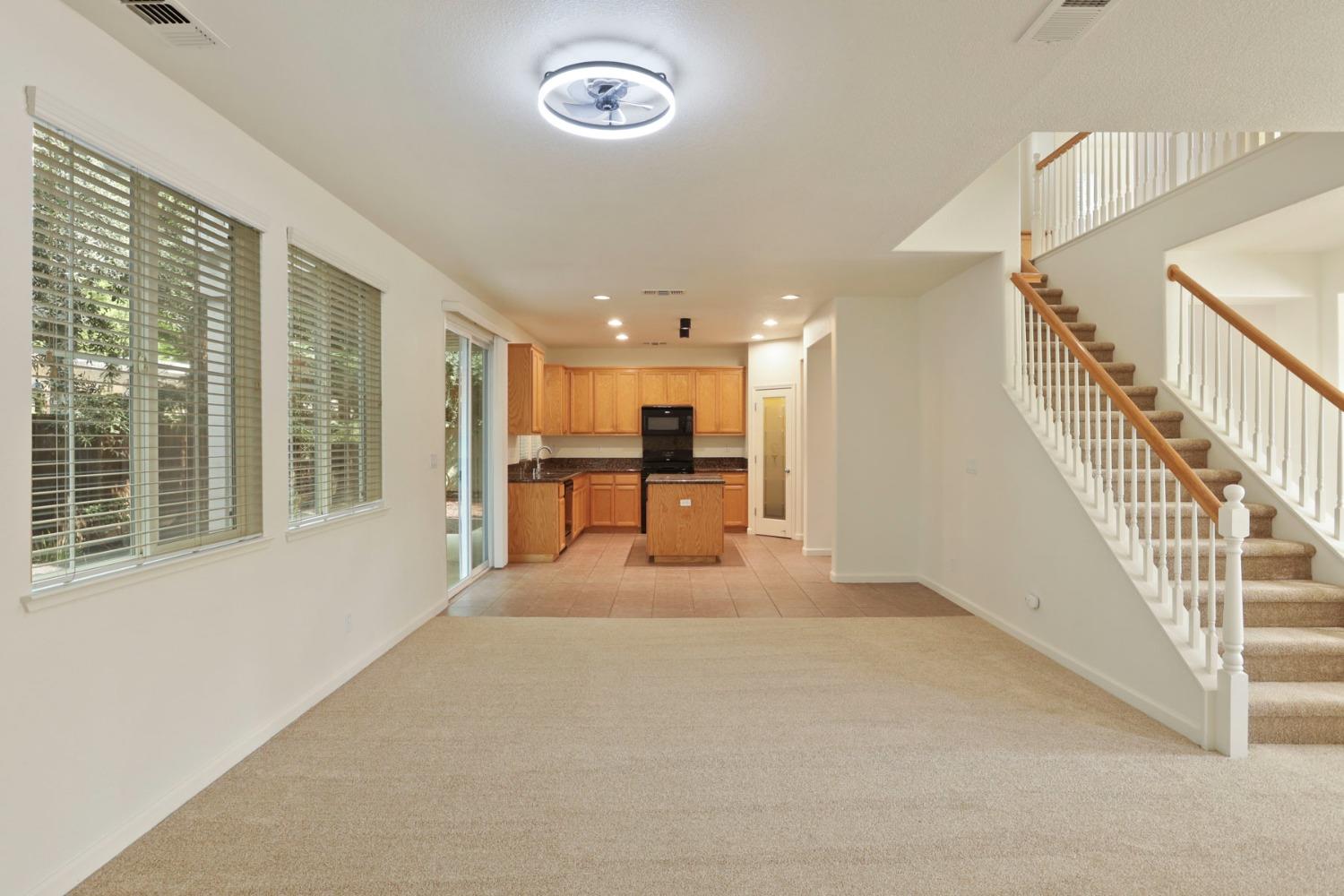 9363 Vintner Circle Patterson, CA 95363 - Photo 11 of 52 a view of a livingroom with furniture stairs and a large window