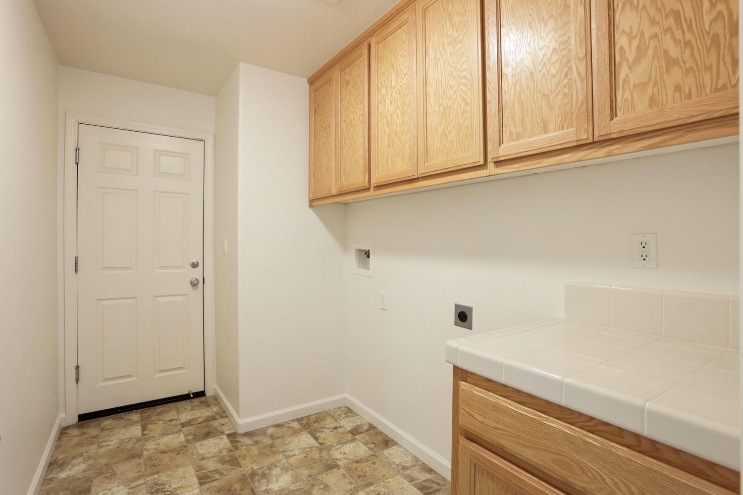 9363 Vintner Circle Patterson, CA 95363 - Photo 23 of 52 a view of kitchen with white cabinets and wooden floor