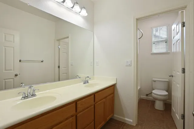 a white toilet sitting next to a bath tub