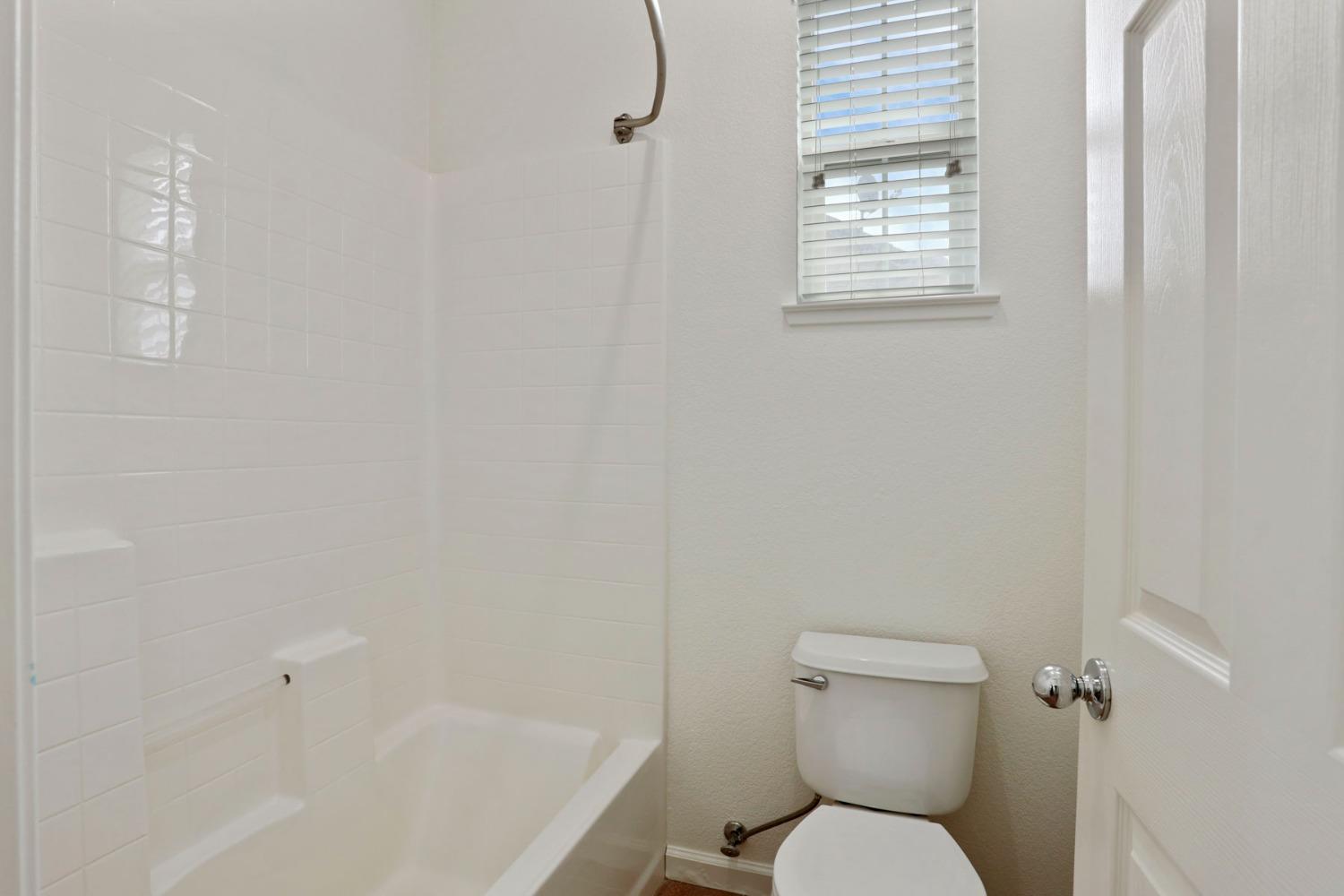 9363 Vintner Circle Patterson, CA 95363 - Photo 26 of 52 a white toilet sitting next to a bath tub