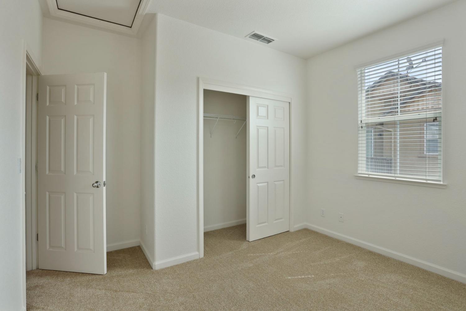 9363 Vintner Circle Patterson, CA 95363 - Photo 28 of 52 a view of an empty room with closet and a window