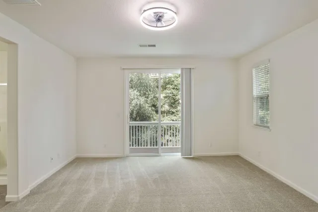 an empty room with windows and closet