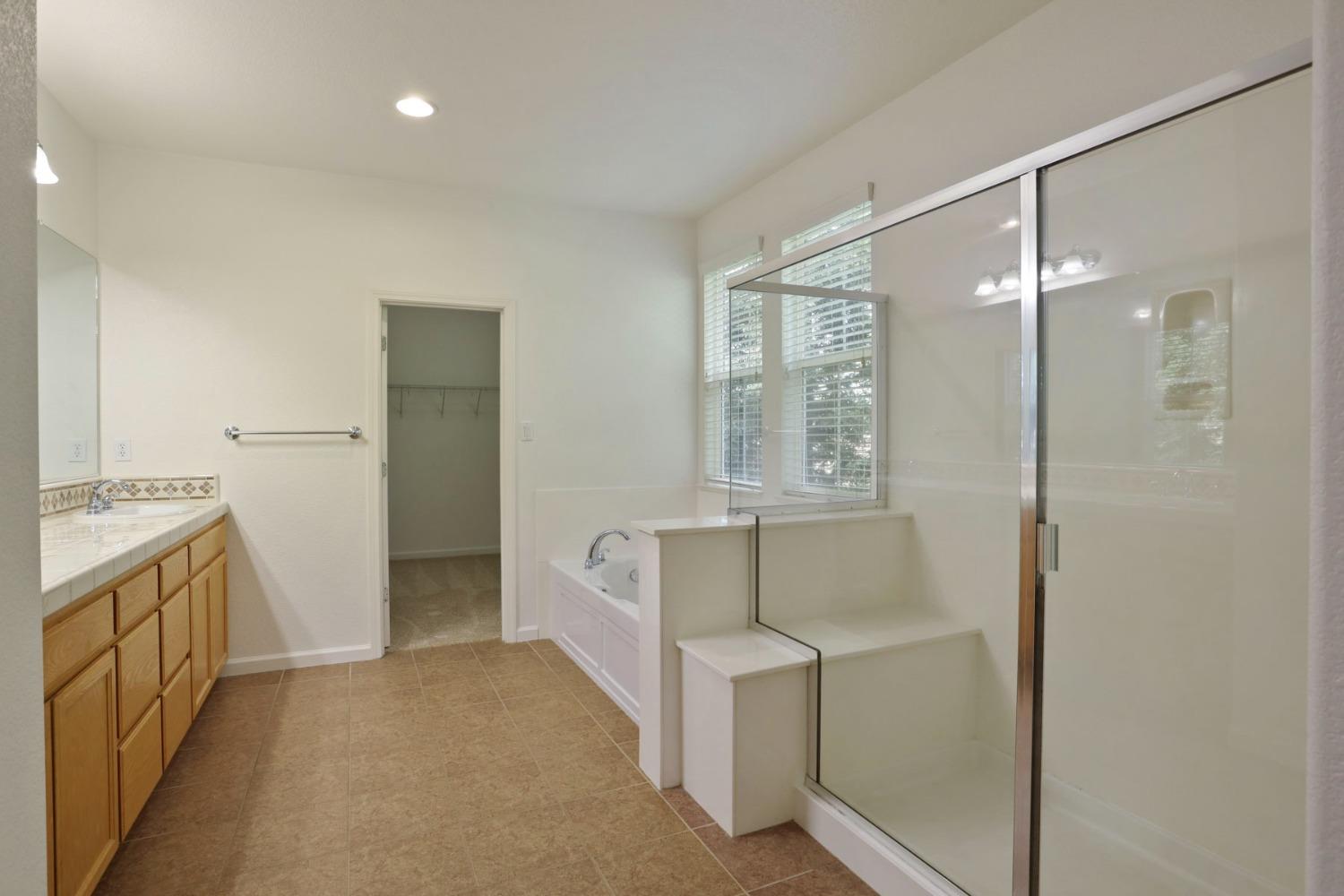 9363 Vintner Circle Patterson, CA 95363 - Photo 37 of 52 a bathroom with a sink and a mirror