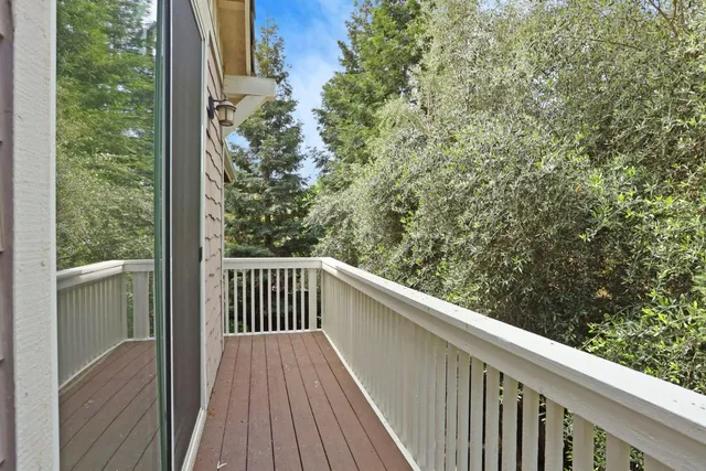 a view of a balcony with wooden floor