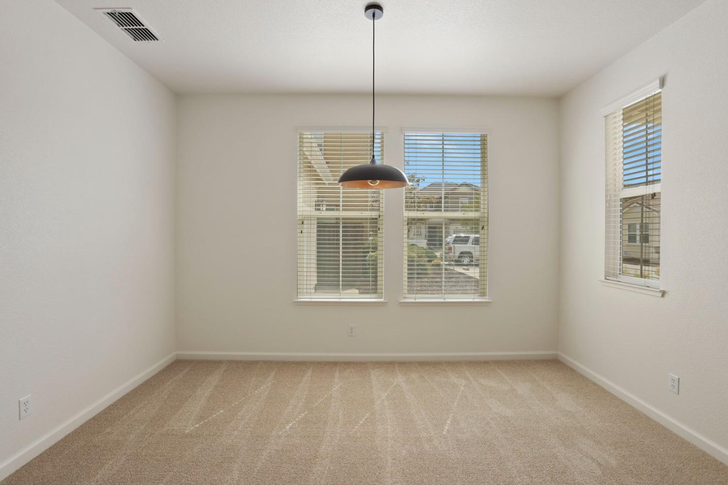 9363 Vintner Circle Patterson, CA 95363 - Photo 5 of 52 a view of an empty room with a window