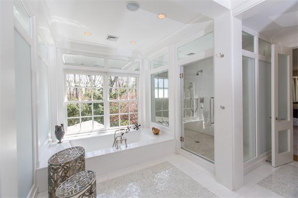 103 Rolling Lane Weston, MA 02493 - Photo 19 of 25 a spacious bathroom with a tub shower and windows