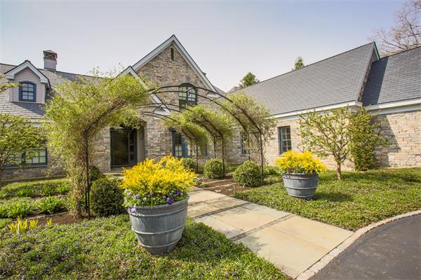 103 Rolling Lane Weston, MA 02493 - Photo 2 of 25 a front view of a house with a garden