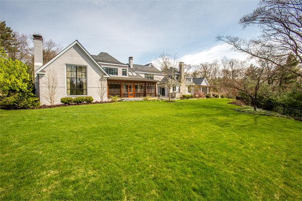 103 Rolling Lane Weston, MA 02493 - Photo 3 of 25 a view of a house with a big yard and large trees