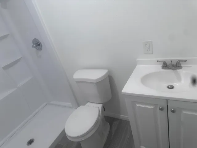 a white toilet sitting next to a bathroom sink