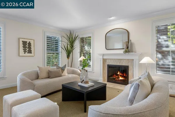 a living room with furniture large window and a table
