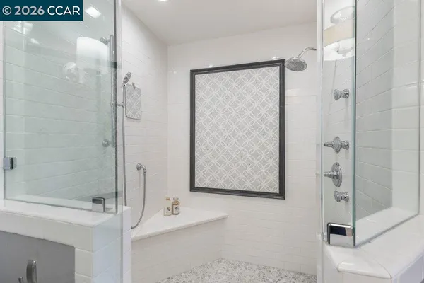 a bathroom with a sink a mirror and a shower