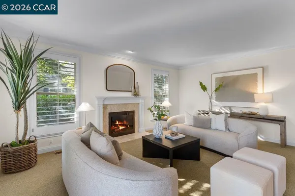 a living room with a fireplace and a table