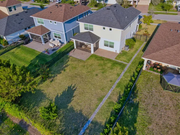 an aerial view of a house with a garden and swimming pool
