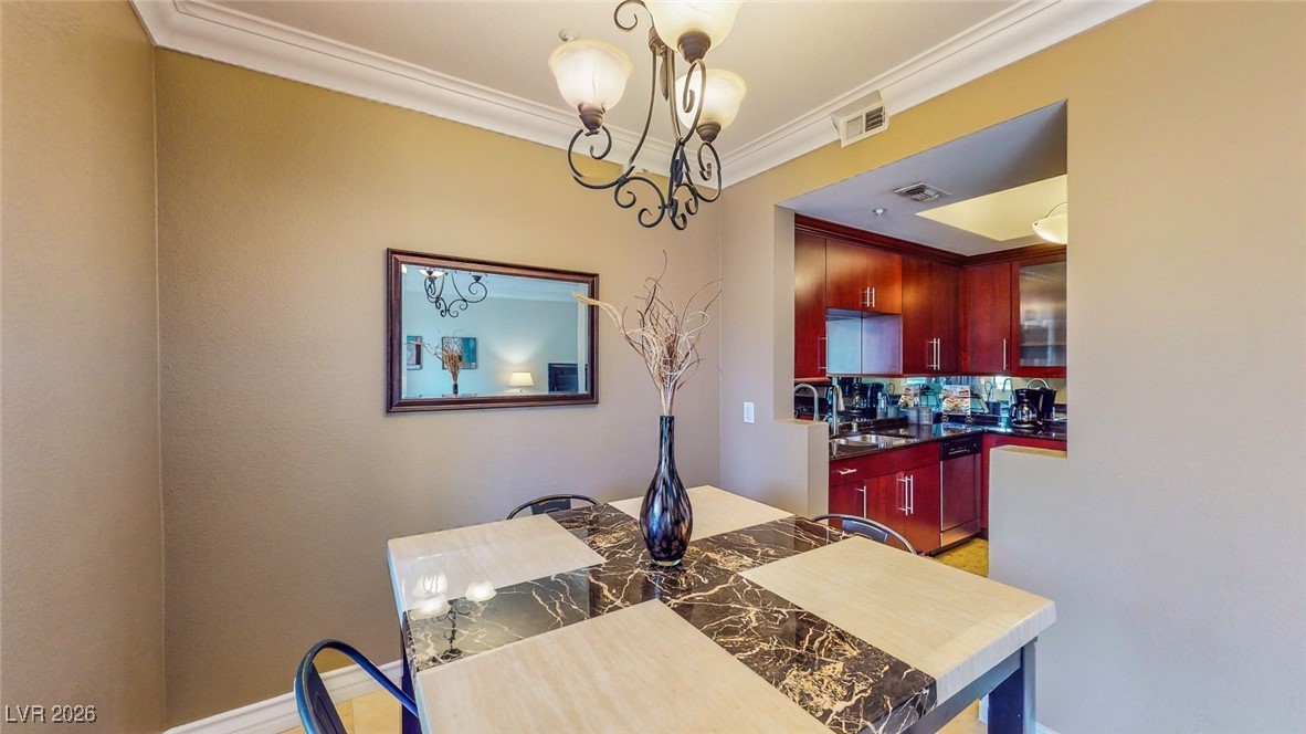 260 East Flamingo Road, Unit 229 Las Vegas, NV 89169 - Photo 24 of 31 Dining area featuring ornamental molding and suspended lighting