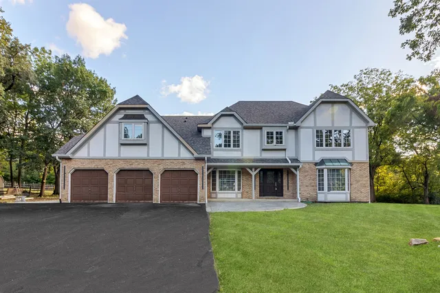 a view of a house with a garden and yard