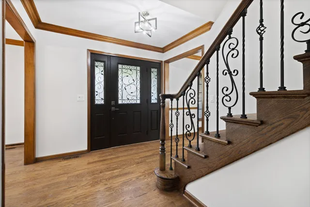 a view of entryway and hall with wooden floor